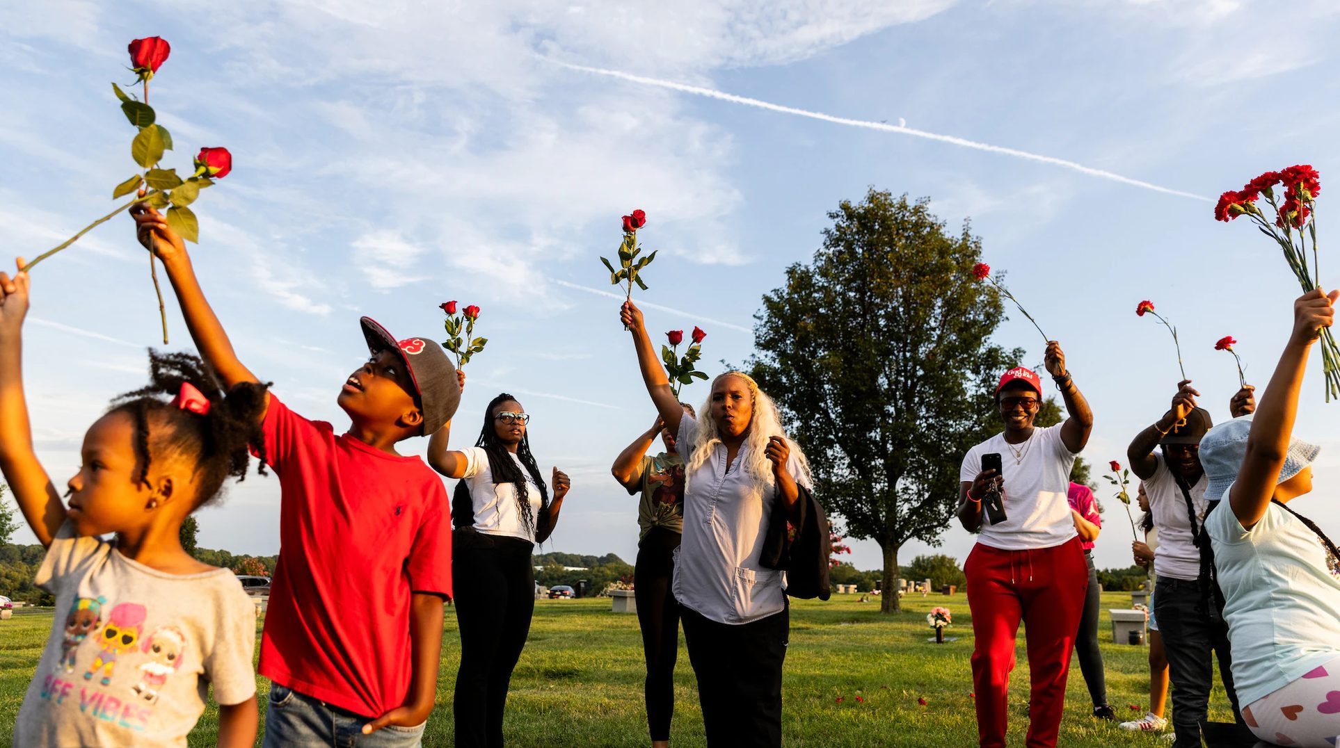 Community gathering with red roses